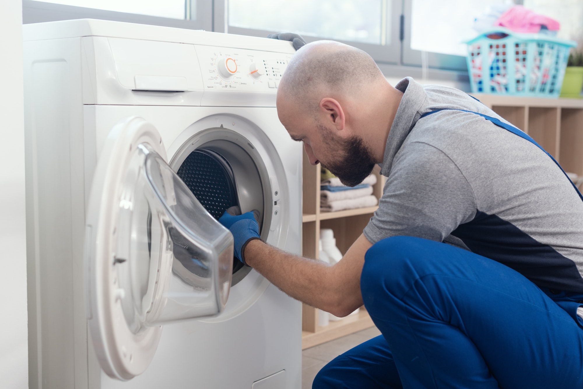 Professional repairman fixing a washer