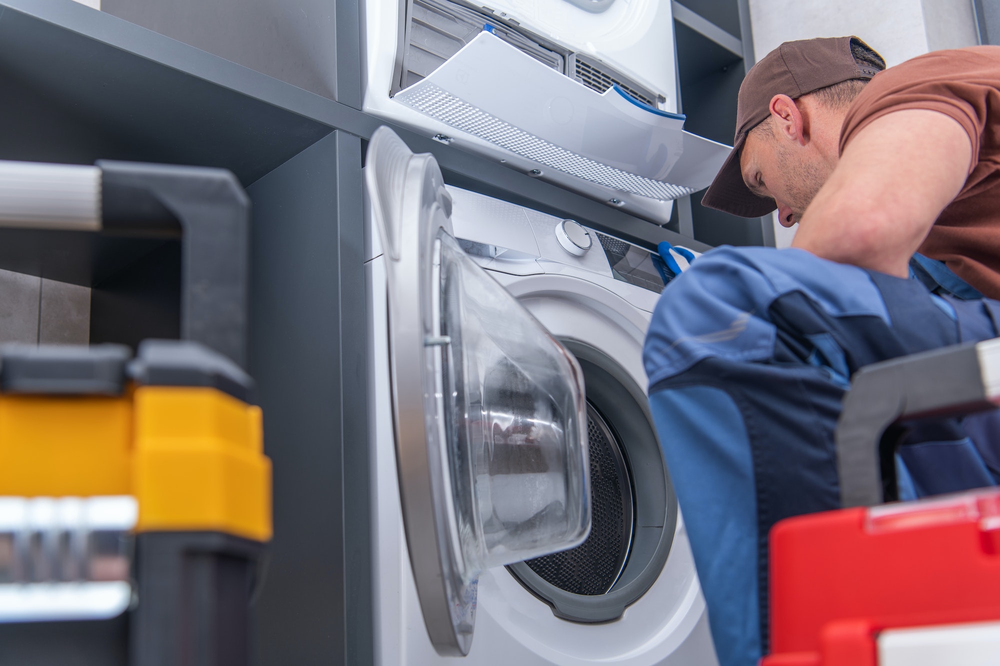 Technician Repairs Broken Washing Machine